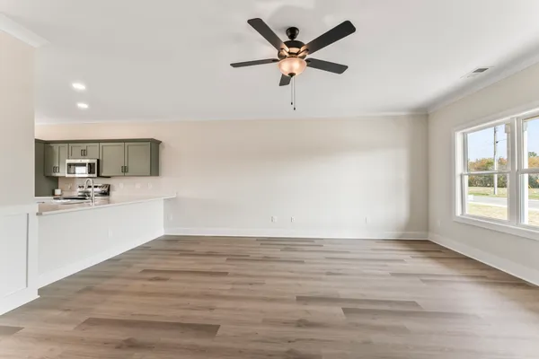 a view of a kitchen with a dishwasher and wooden floor