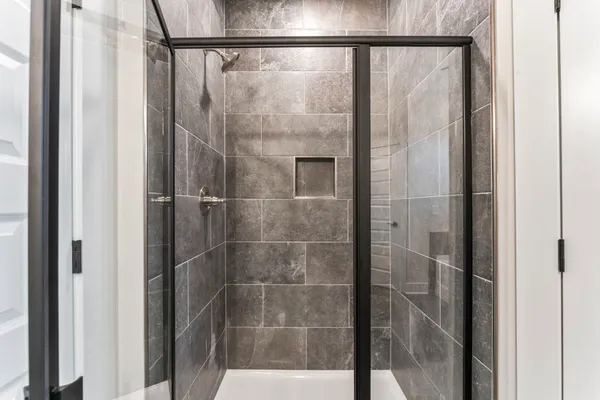 a bathroom with a glass shower door