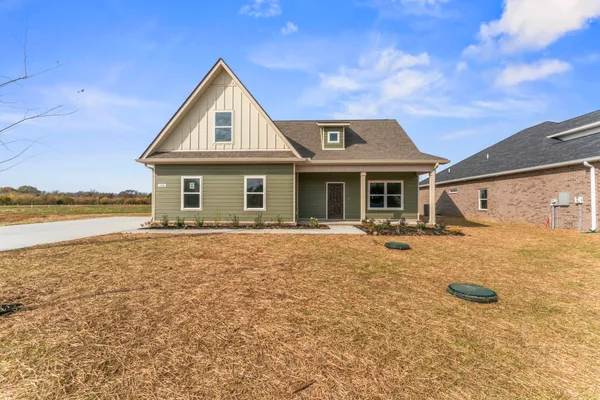 a front view of a house with yard and porch