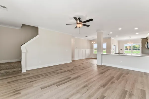 a view of a kitchen with a sink and a refrigerator