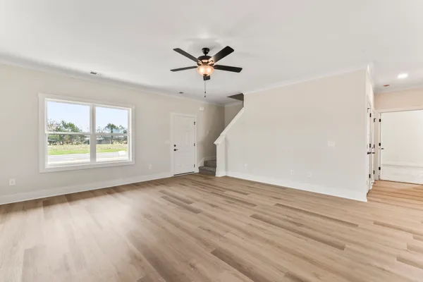 wooden floor in an empty room with a window