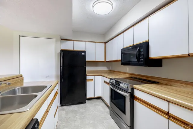 a kitchen with a refrigerator stove and microwave