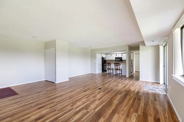 a view of empty room with wooden floor
