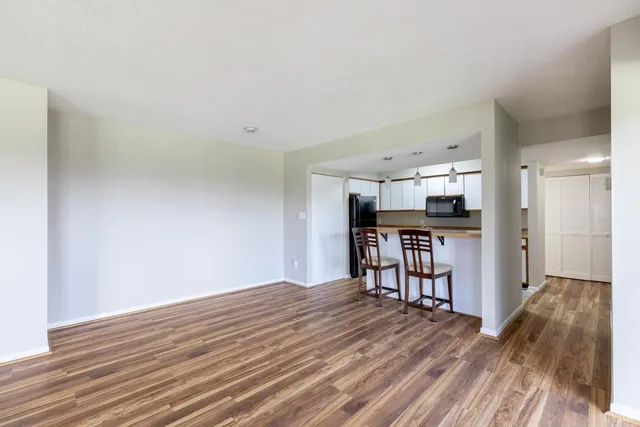 a view of a livingroom with kitchen and furniture