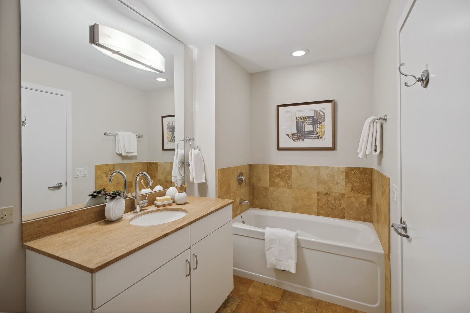 125 South Green Street, Unit 409A Chicago, IL 60607 - Photo 13 of 18 a bathroom with a tub sink and mirror