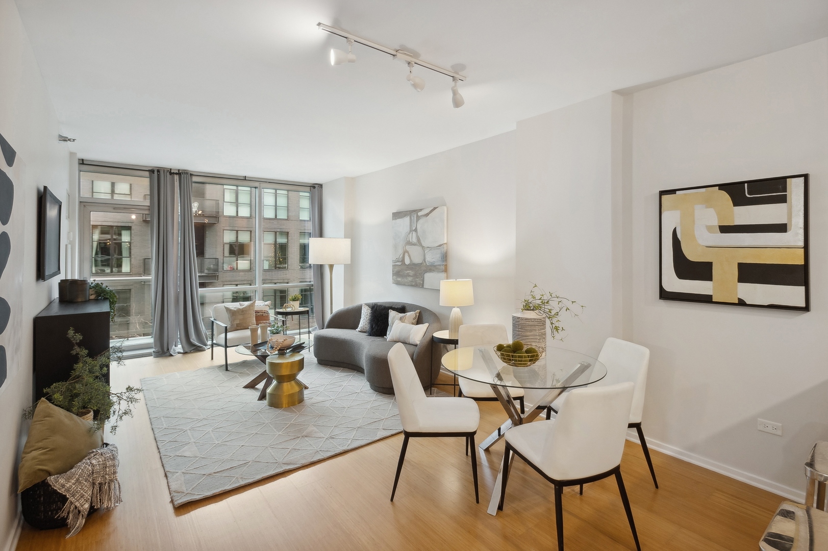 125 South Green Street, Unit 409A Chicago, IL 60607 - Photo 4 of 18 a living room with furniture and wooden floor