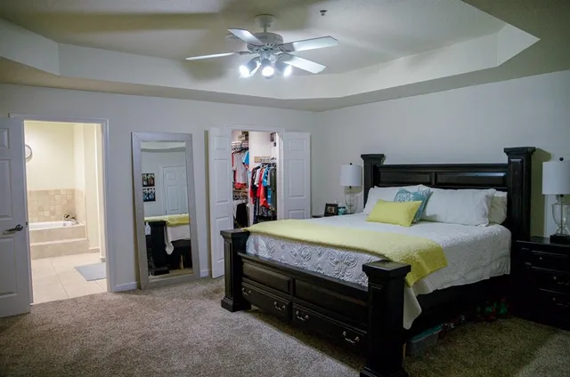 a bed room with a bed and a chandelier