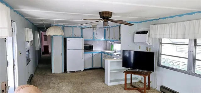 a kitchen with refrigerator and window