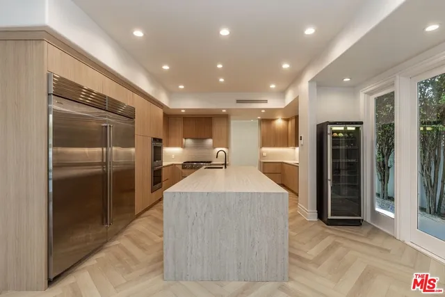 a large kitchen with stainless steel appliances kitchen island a large counter top