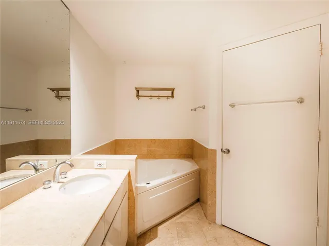 a bathroom with a tub and a sink