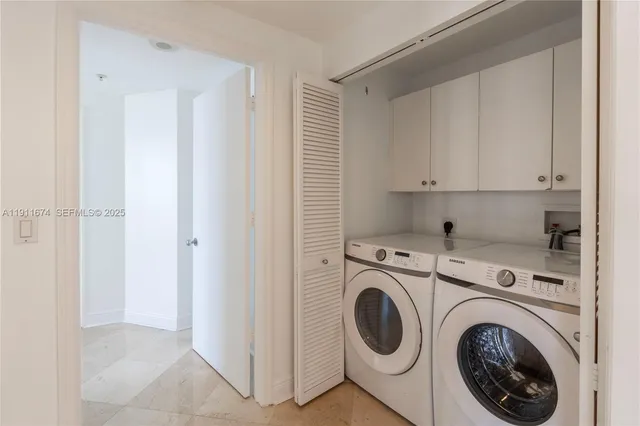 a view of storage and utility room with washer and dryer