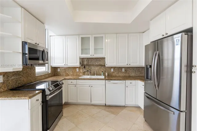 a kitchen with stainless steel appliances a refrigerator sink and microwave