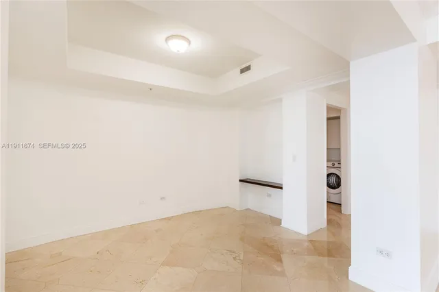 a view of a big room with closet and windows