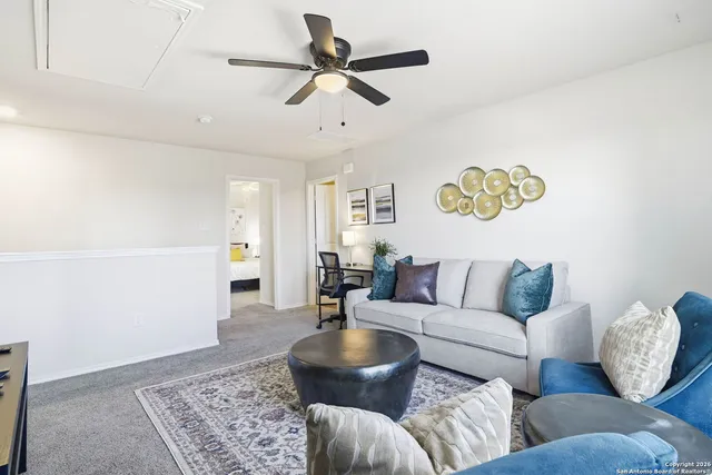a living room with furniture and a rug