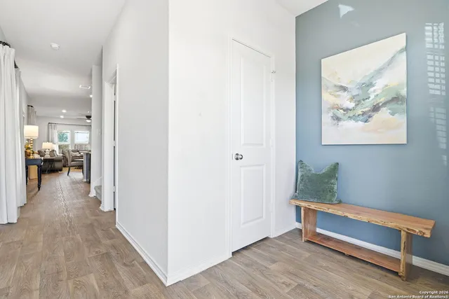 a view of hallway with livingroom and furniture