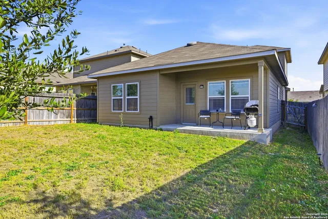 a view of a house with pool and chairs