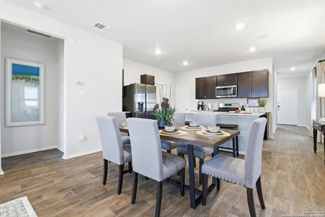 a view of a dining room with furniture and wooden floor
