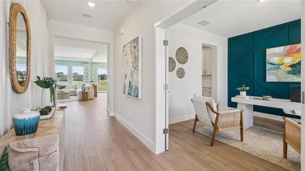 a living room with furniture a flat screen tv and a floor to ceiling window