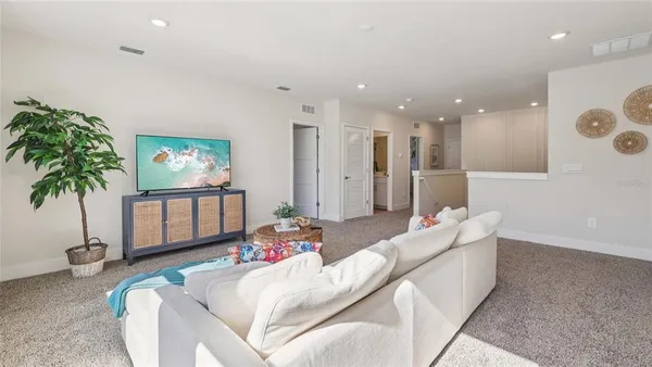 a living room with furniture and potted plant