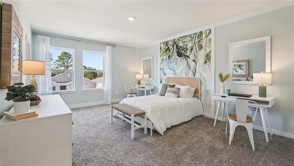 a spacious bedroom with a bed and a table in it