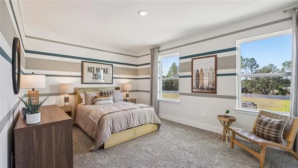 a bedroom with a bed and a couch