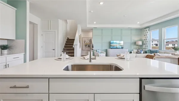a view with kitchen island a sink and a refrigerator