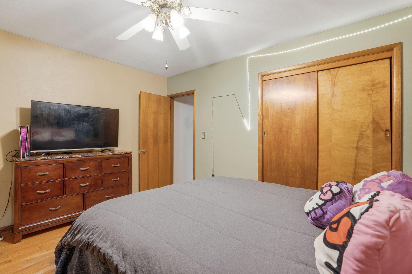 2730 4th Street Moline, IL 61265 - Photo 12 of 25 a bedroom with a bed and a flat screen tv on dresser