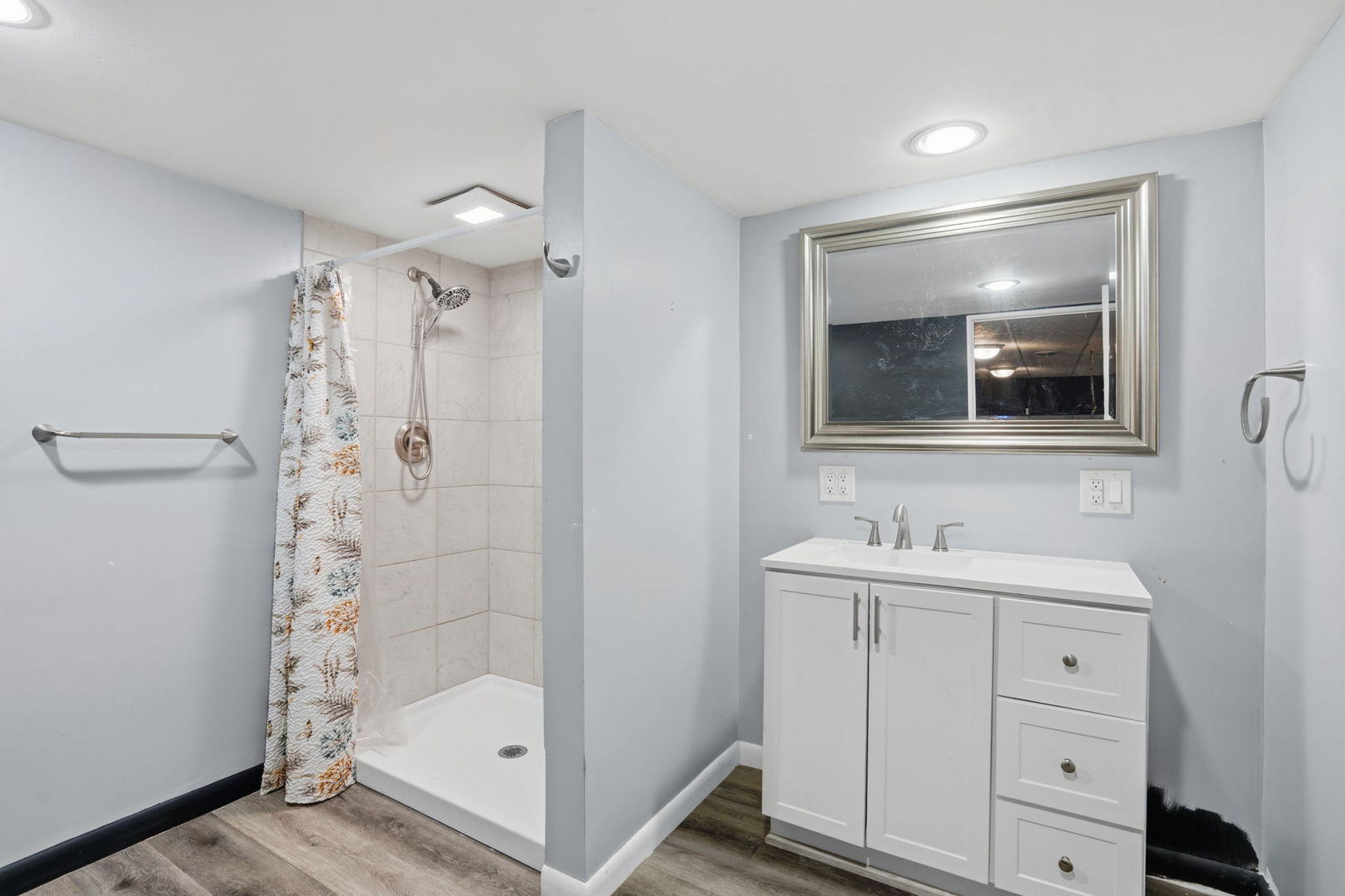 2730 4th Street Moline, IL 61265 - Photo 19 of 25 a bathroom with a shower a sink and a mirror