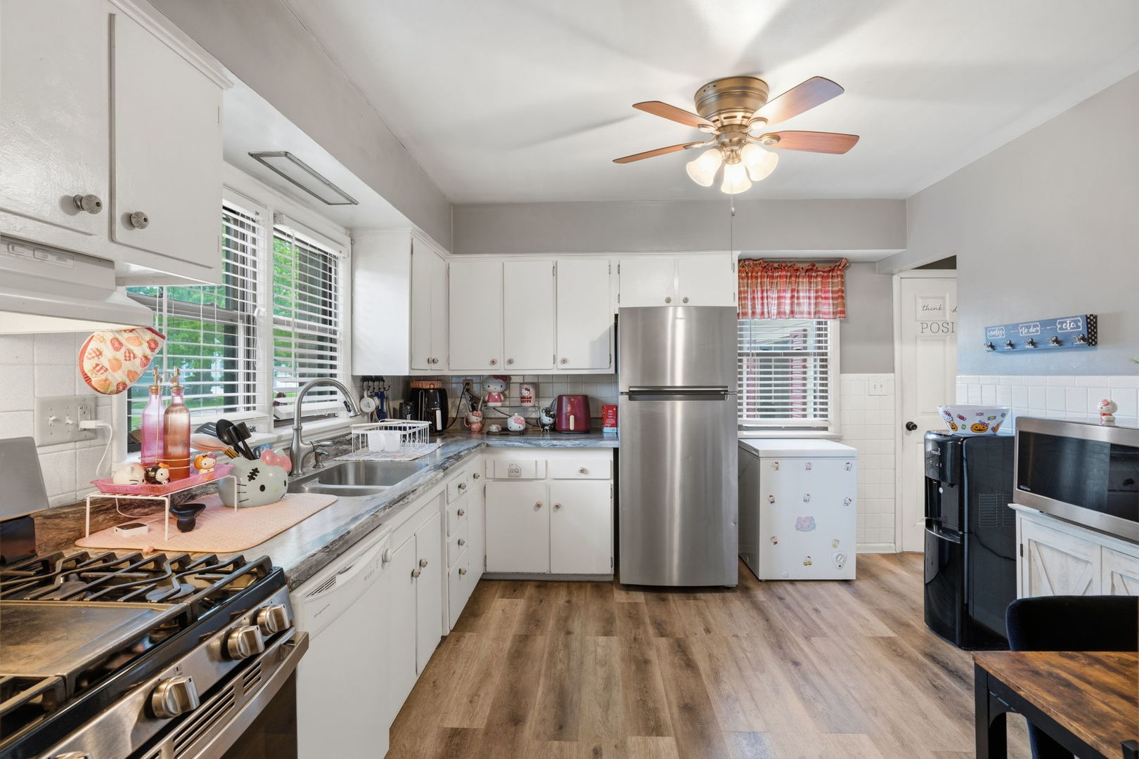 2730 4th Street Moline, IL 61265 - Photo 8 of 25 a kitchen with a sink cabinets stainless steel appliances and a window
