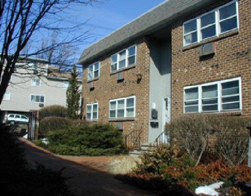 637 Cove Road, Unit D16 Stamford, CT 06902 - Photo 1 of 1 a front view of a house with a yard