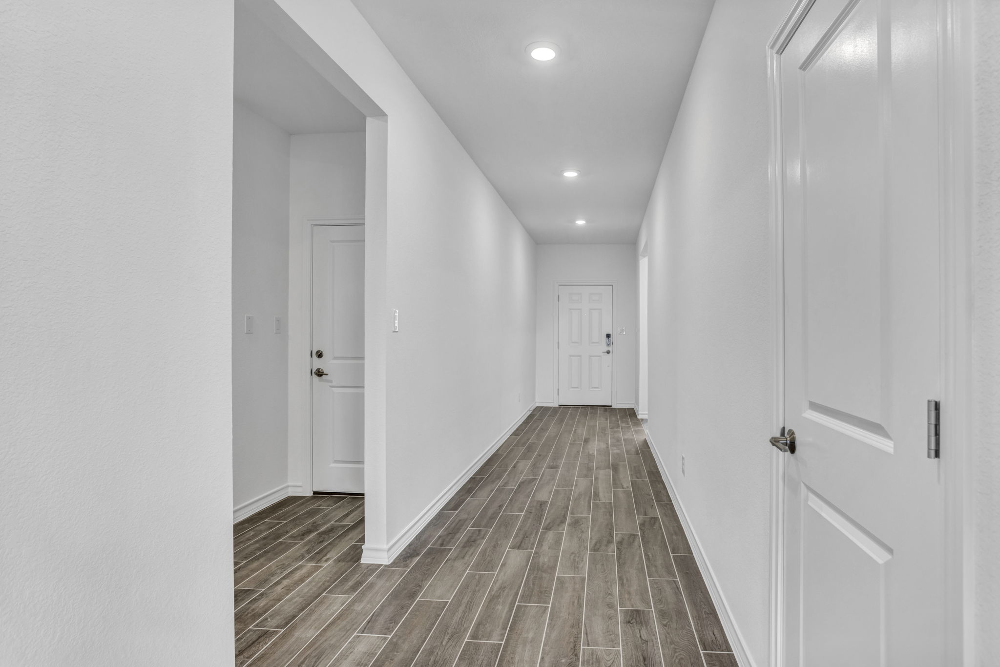 131 Adeline Road Hutto, TX 78634 - Photo 13 of 30 Clean lines and a spacious walkway define this entry with recessed lighting and contemporary flooring.