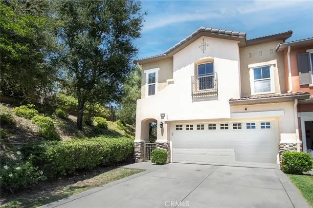 a view of a house with a yard and potted plants