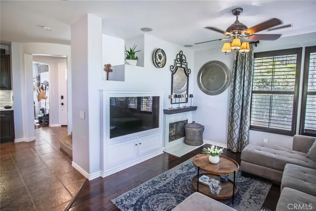 a living room with furniture a rug and a fireplace