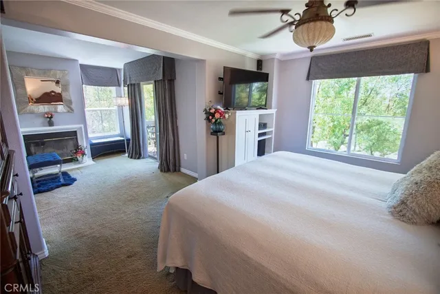 a bedroom with a bed closet and a large window