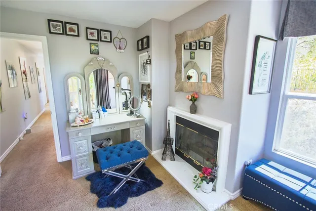 a living room with furniture a window and a fireplace