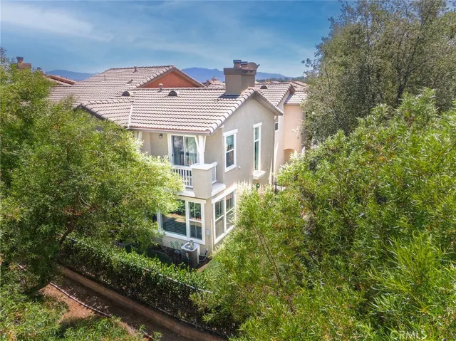 an aerial view of a house with a yard and balcony