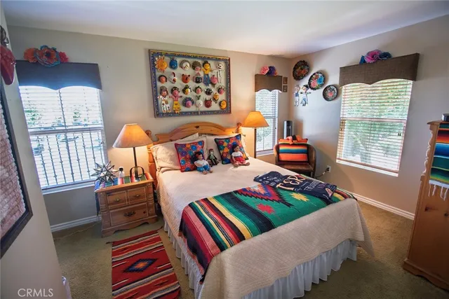 a bedroom with a bed and a painting on the wall