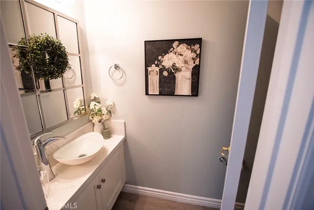 a bathroom with a sink mirror and vanity