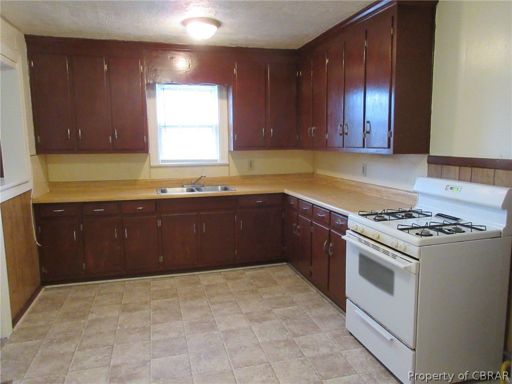 430 Alleghany Road Hampton, VA 23661 - Photo 8 of 19 a kitchen with a stove sink and cabinets