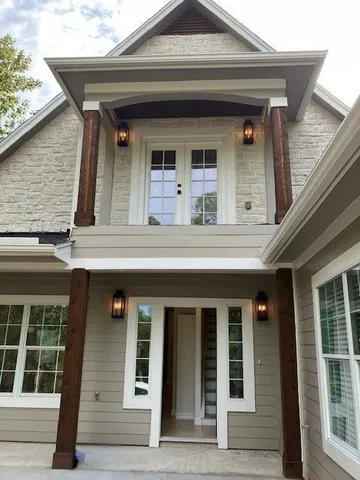 an aerial view of a house with a lake view