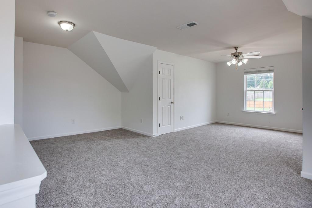 1038 Golf View Way Spring Hill, TN 37174 - Photo 14 of 16 an empty room with windows and chandelier fan