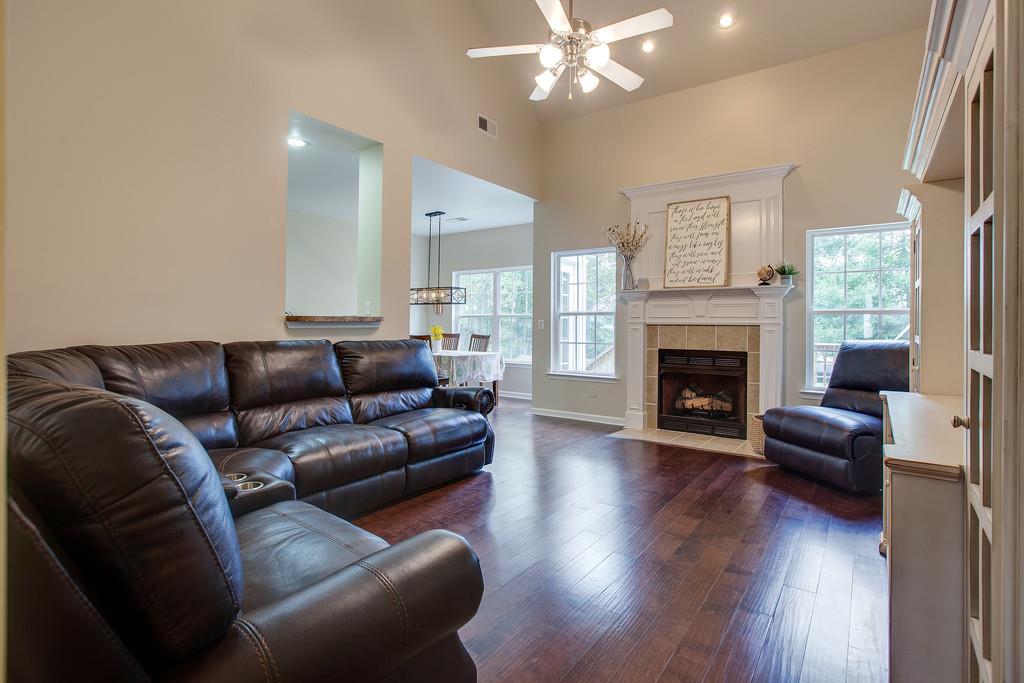 1038 Golf View Way Spring Hill, TN 37174 - Photo 4 of 16 a living room with furniture a fireplace and wooden floor