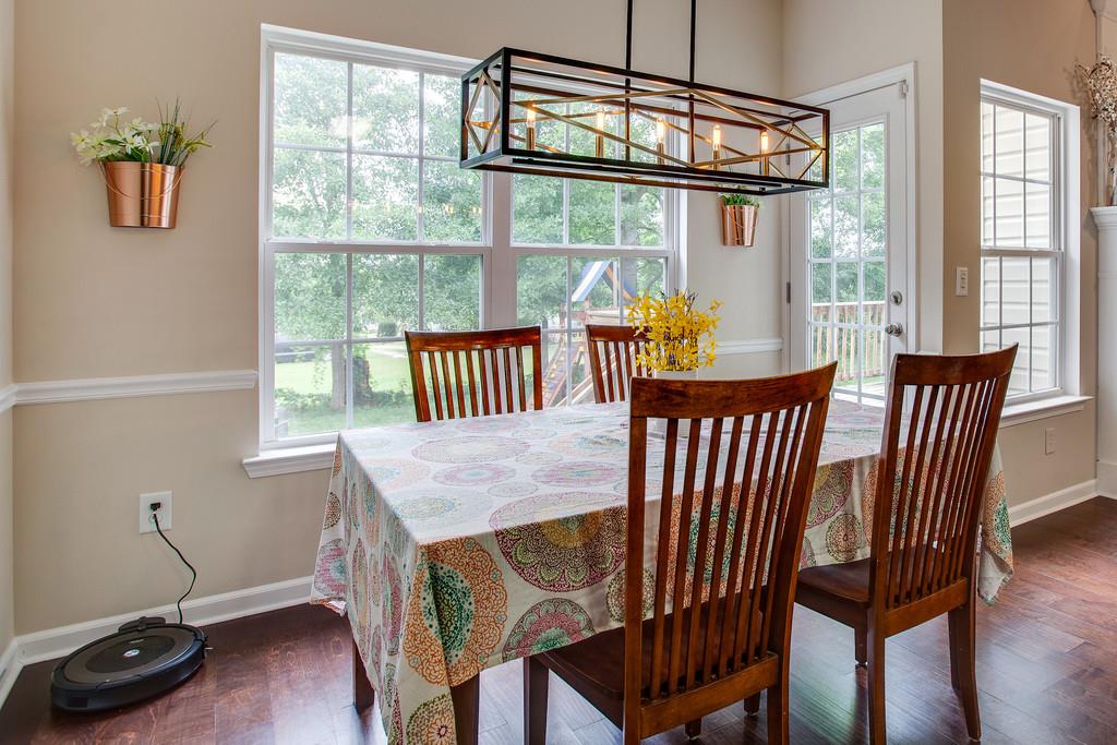 1038 Golf View Way Spring Hill, TN 37174 - Photo 5 of 16 a view of a dining room with furniture a chandelier and wooden floor