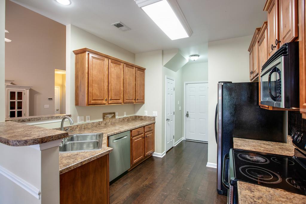1038 Golf View Way Spring Hill, TN 37174 - Photo 6 of 16 a kitchen with a sink stove and refrigerator