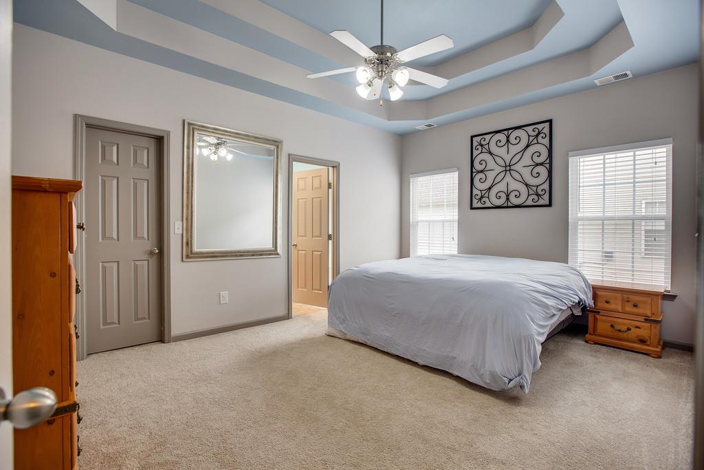 1038 Golf View Way Spring Hill, TN 37174 - Photo 9 of 16 a bedroom with a bed and a chandelier