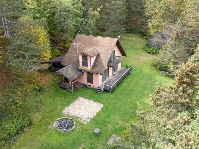an aerial view of a house with a yard