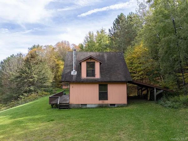 a backyard of a house with table and chairs