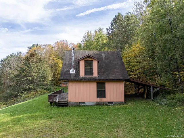 a backyard of a house with table and chairs