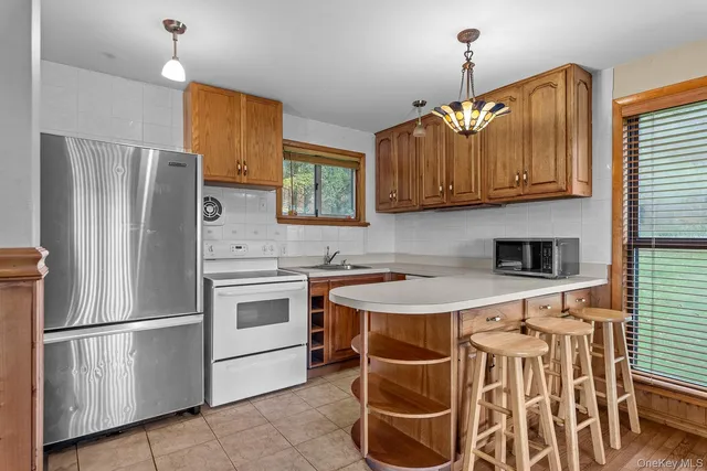 a kitchen with stainless steel appliances a stove a sink and a refrigerator