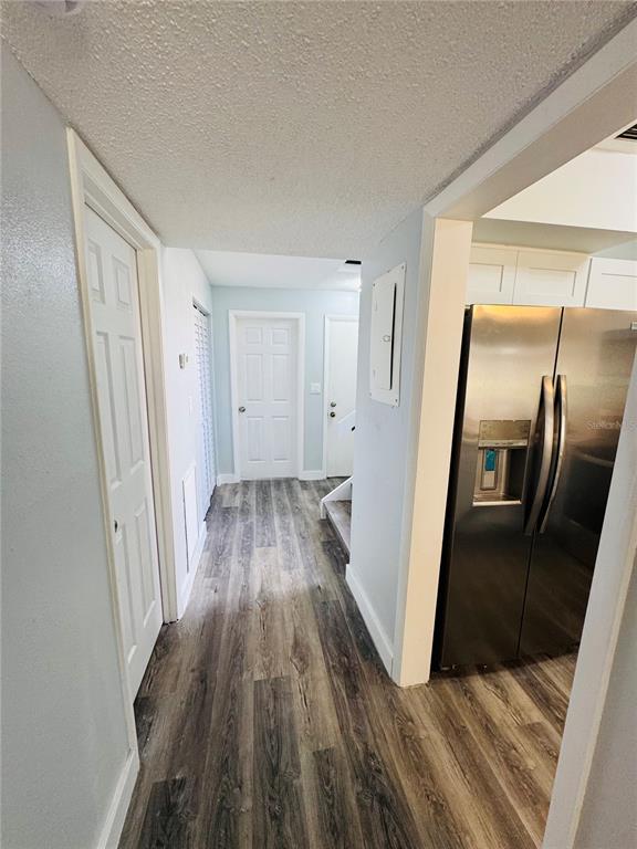 4100 Player Circle, Unit 101 Orlando, FL 32808 - Photo 13 of 34 a view of a hallway with wooden floor